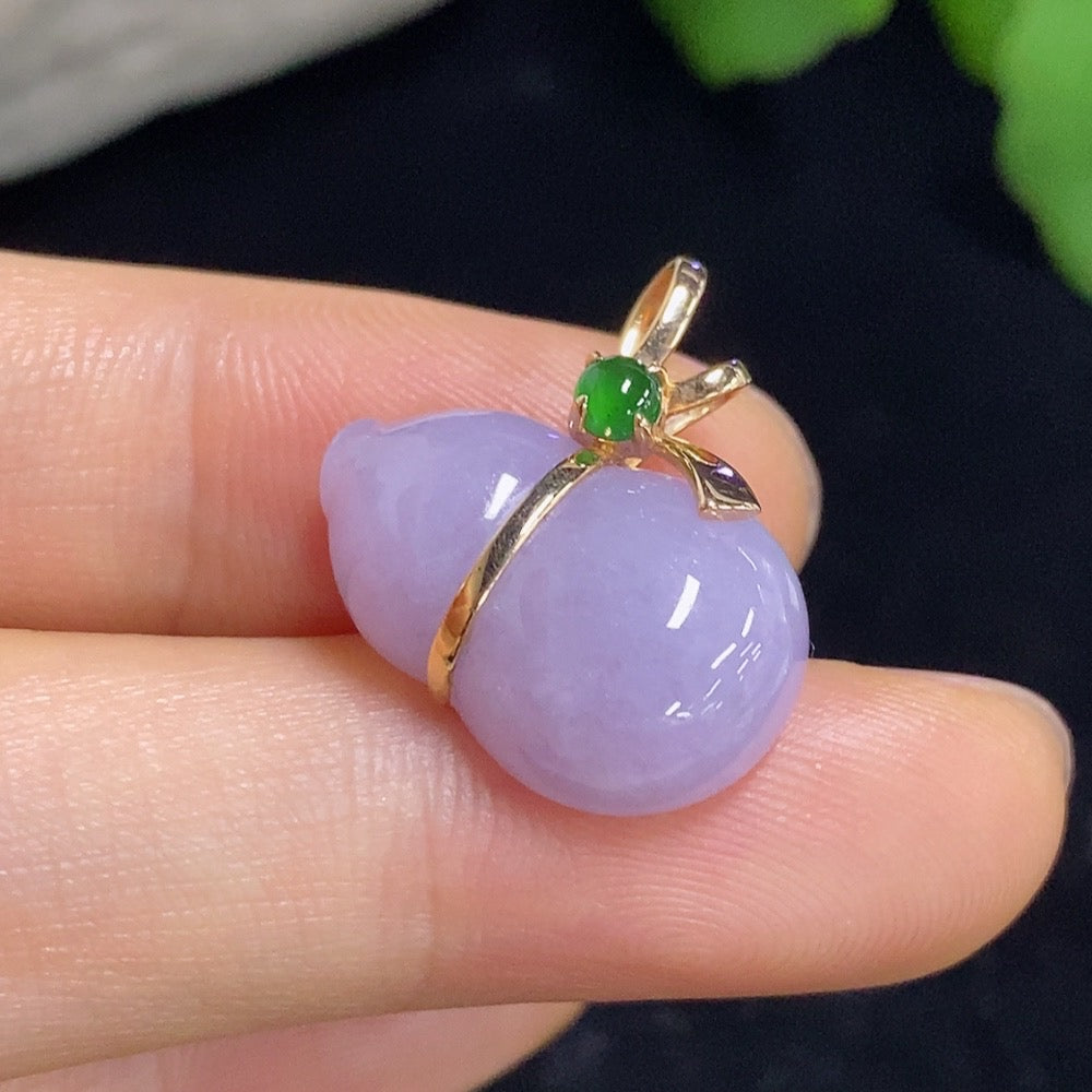 Jadeite gourd pendant inlaid with 18K gold, hanging on a necklace, showcasing intricate craftsmanship and vibrant green jade.