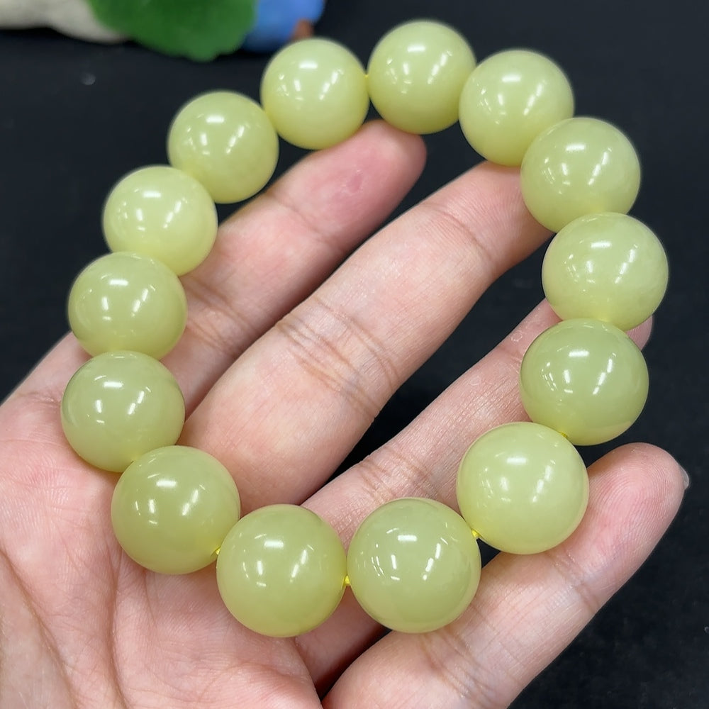 HKHQ Hetian Jade bracelet with 15.9mm beads, showcasing smooth, polished green jade stones on a white background.