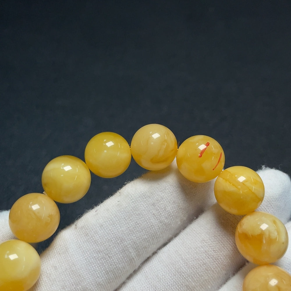 Amber beeswax bracelet with partial visible repairs, total weight approximately 18.25g, size about 12.6mm