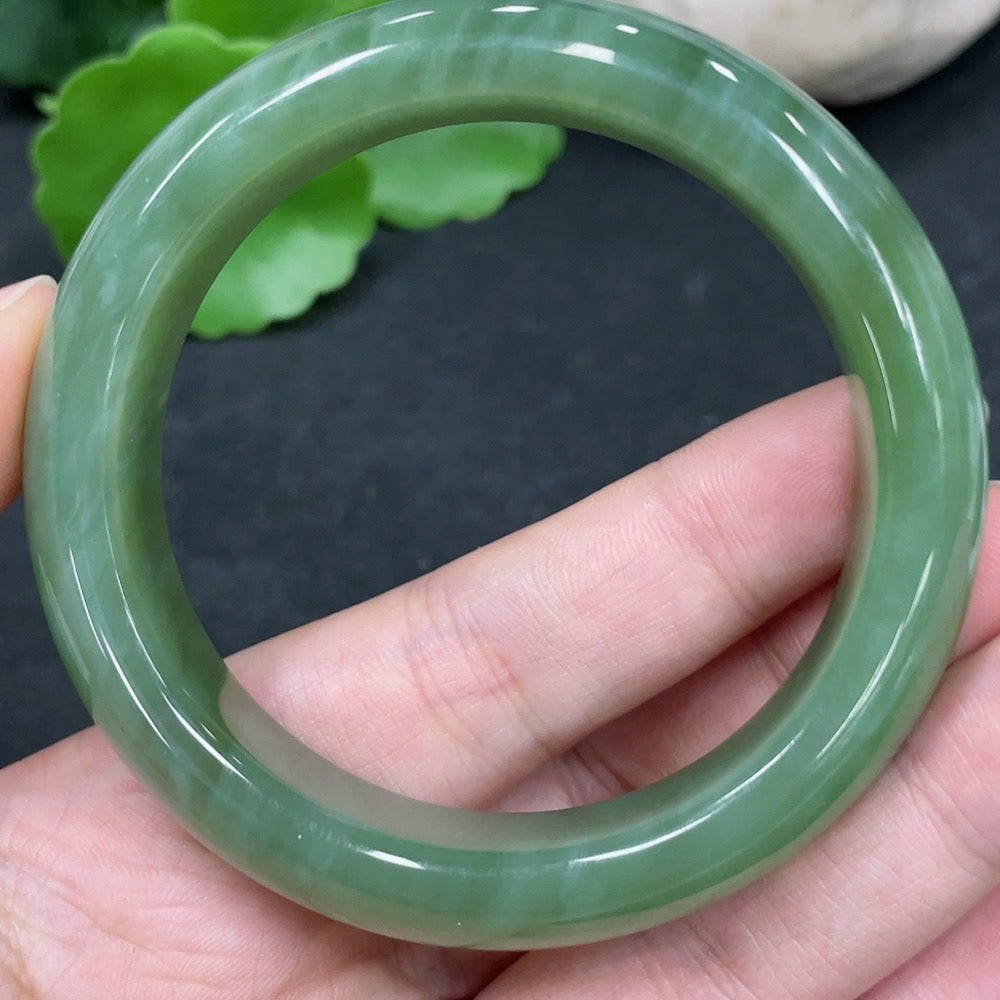 Huiliu Certified Hetian Jade round bracelet featuring smooth, polished jade beads on a string, showcasing elegant craftsmanship.