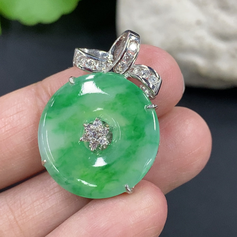 Jadeite Peace Knot pendant with 18k gold setting and diamond accents, shown on a necklace chain.