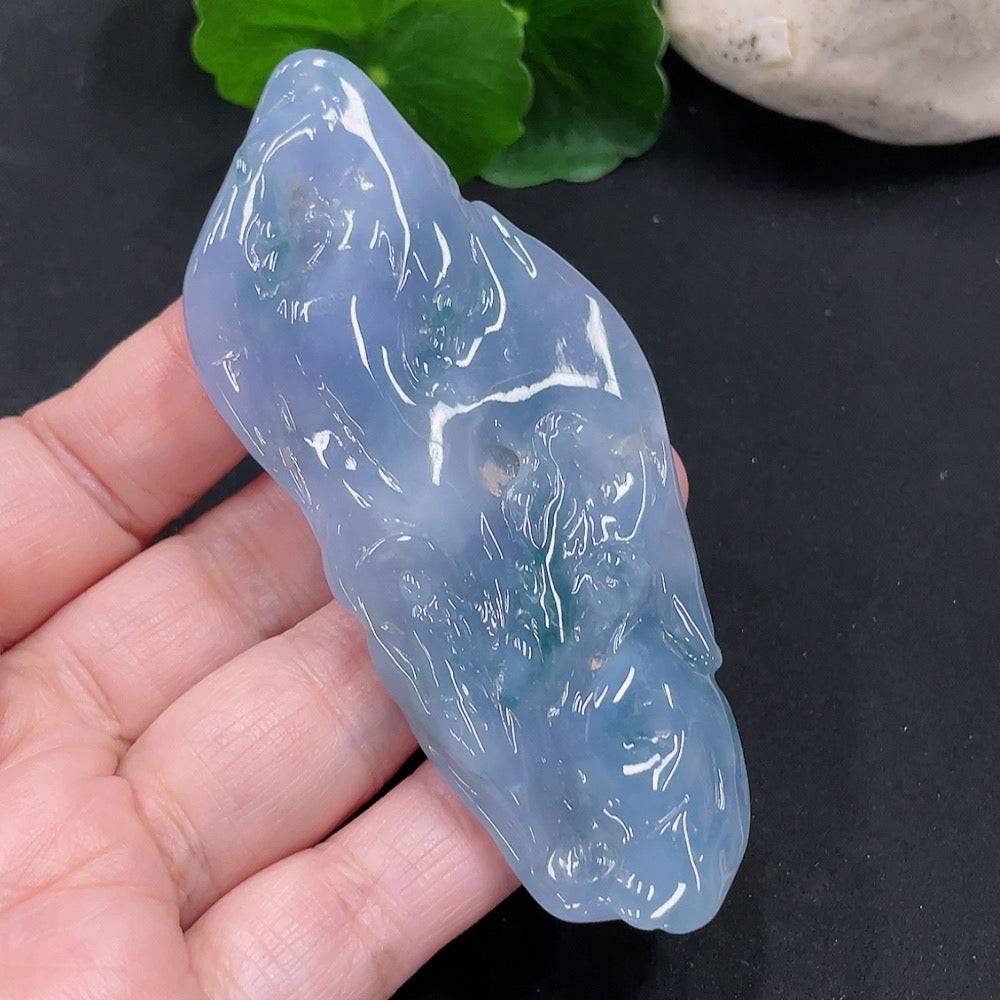 Huiliu Jadeite Enlightenment Pendant showcasing smooth, polished green jade with intricate carvings on a plain background.