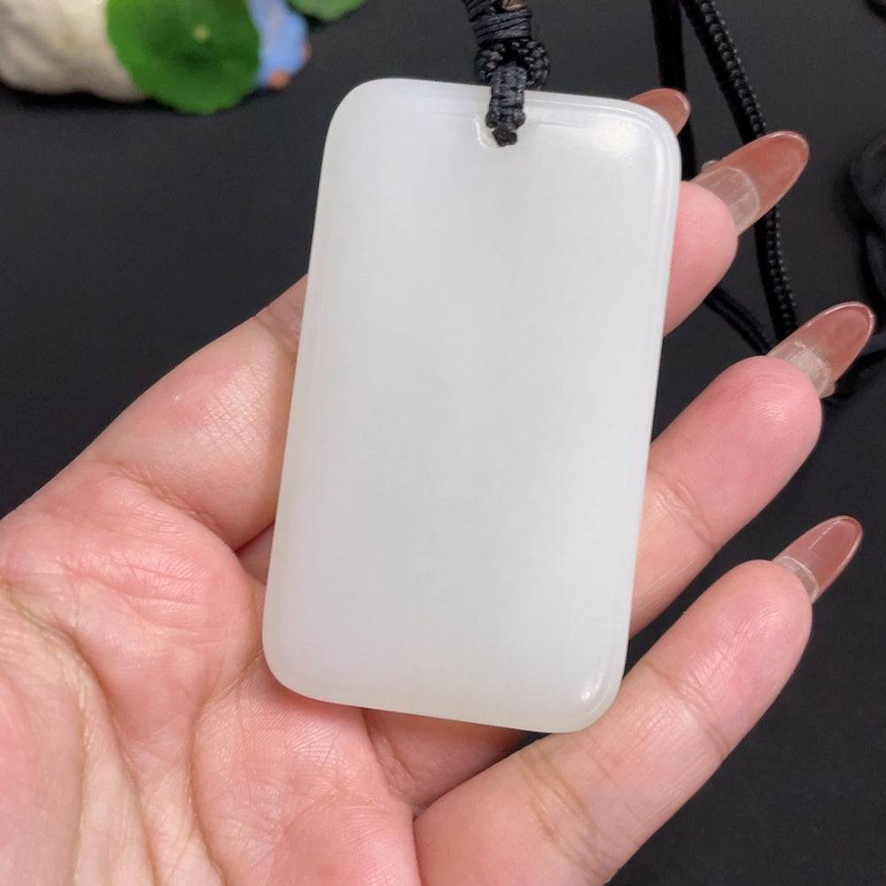 Huiliu certified Hetian jade pendant featuring Guanyin figure with rope, showcasing intricate craftsmanship and smooth jade surface.
