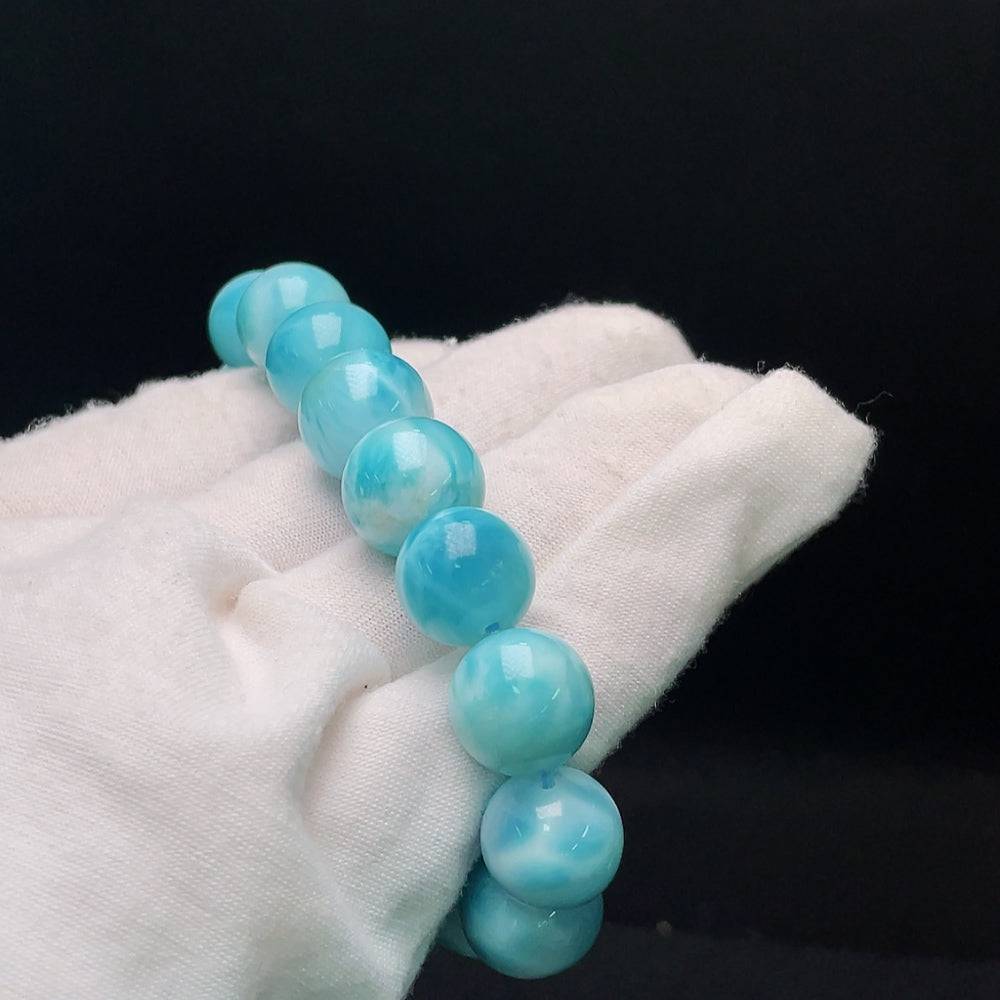 Larimar gemstone bracelet with organic matter, weighs 56.14g, 13.8mm size, featuring natural blue stones and earthy inclusions.