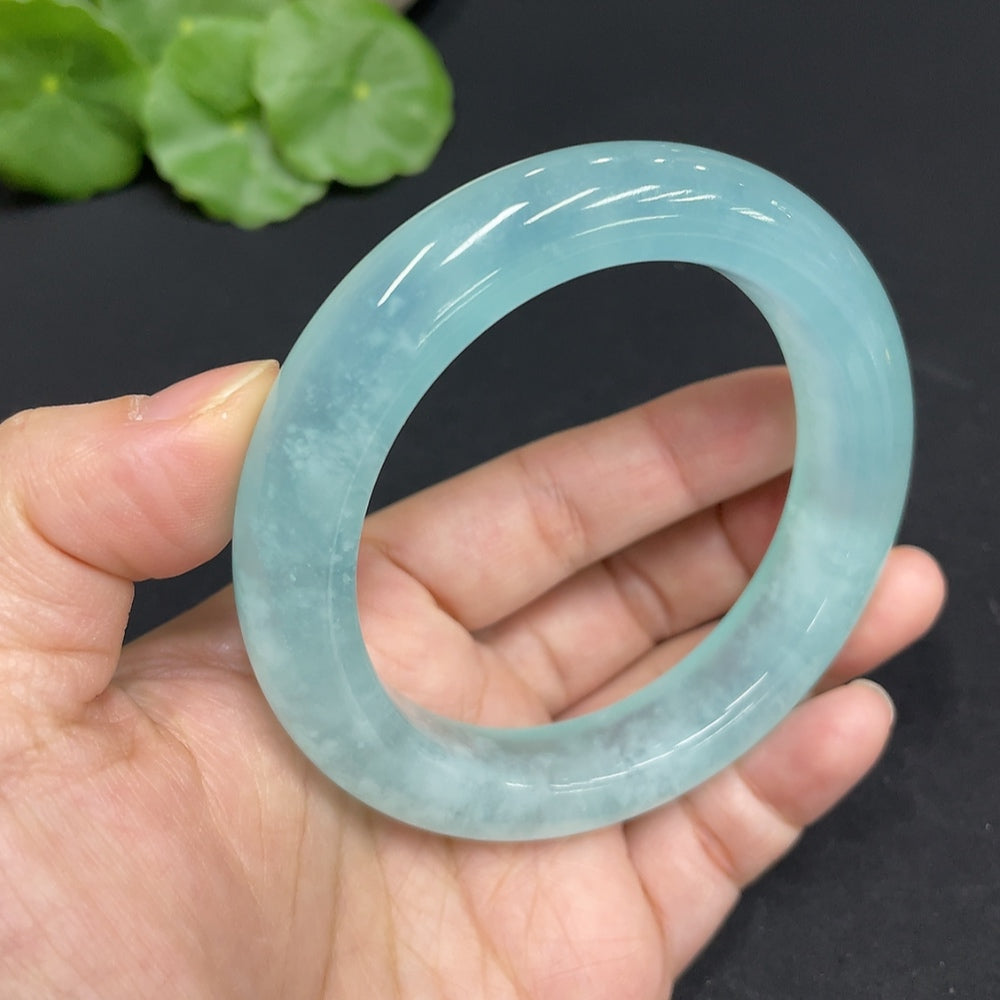 Huiliu Celestial Blue Frost jade bracelet with round serpentine jade beads, Huiliu certified, on a neutral background.