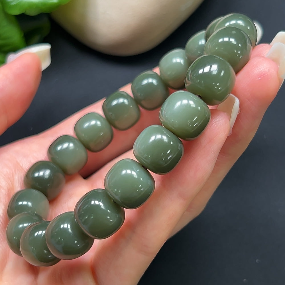 Hetian Jade bracelet with 12mm smooth jade beads, showcasing elegant craftsmanship and natural green hues, by HKHQ.