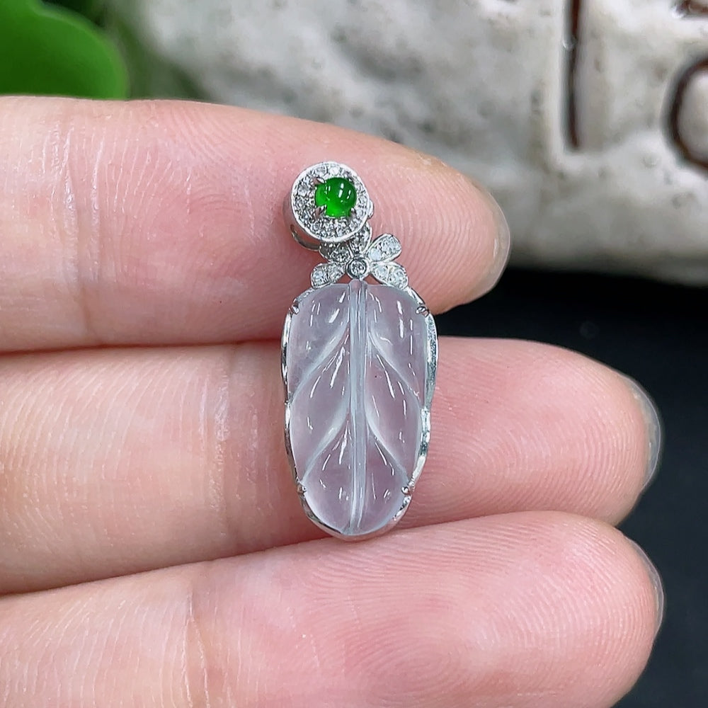 Jadeite pendant with 18k gold setting and diamond accents, featuring a smooth, polished jade stone on a delicate chain.