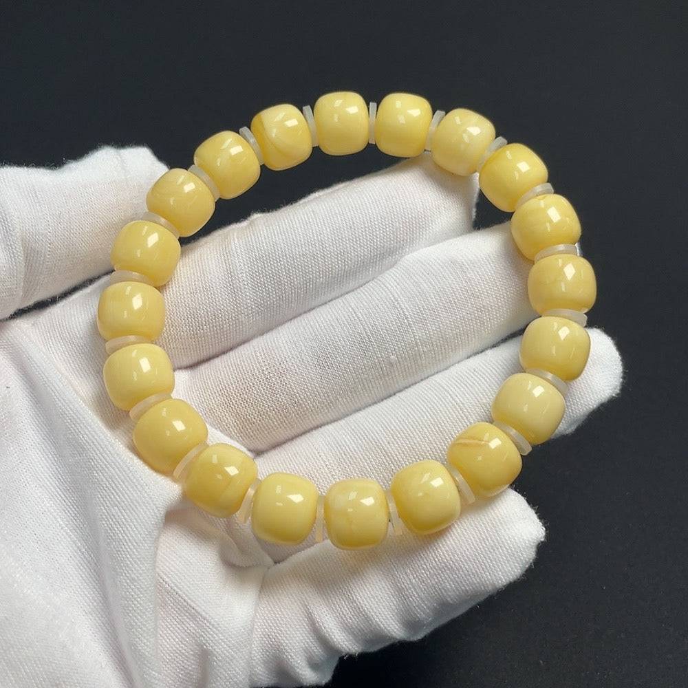 Amber beeswax bead bracelet with 10.5mm beads, crafted by HUILIU HQ, showing a close-up of the warm amber beads and bracelet design.