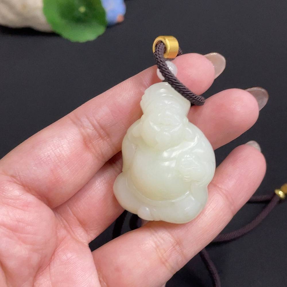 Hetian jade pendant featuring the God of Wealth, weighing approximately 34.8g, with a detailed jade carving and attached rope.