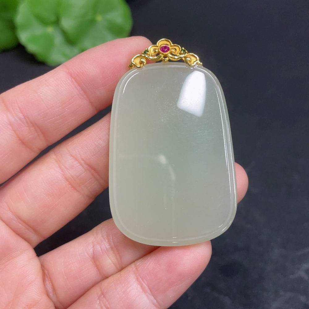 Huiliu certified Hetian jade pendant with plain design and clasp, showcasing smooth, polished jade in a natural light.