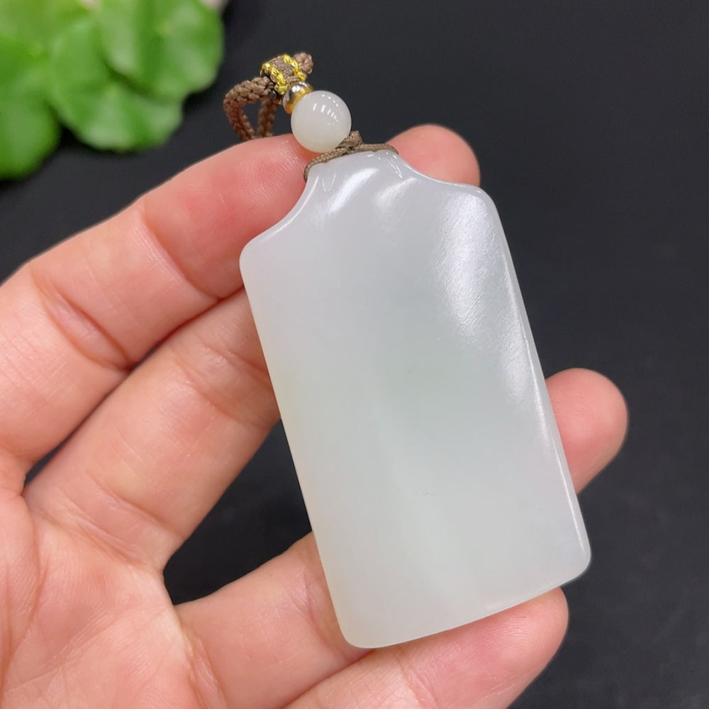 Huiliu certified Hetian jade pendant, plain jade pendant with smooth, polished surface, showcasing natural green and white hues.