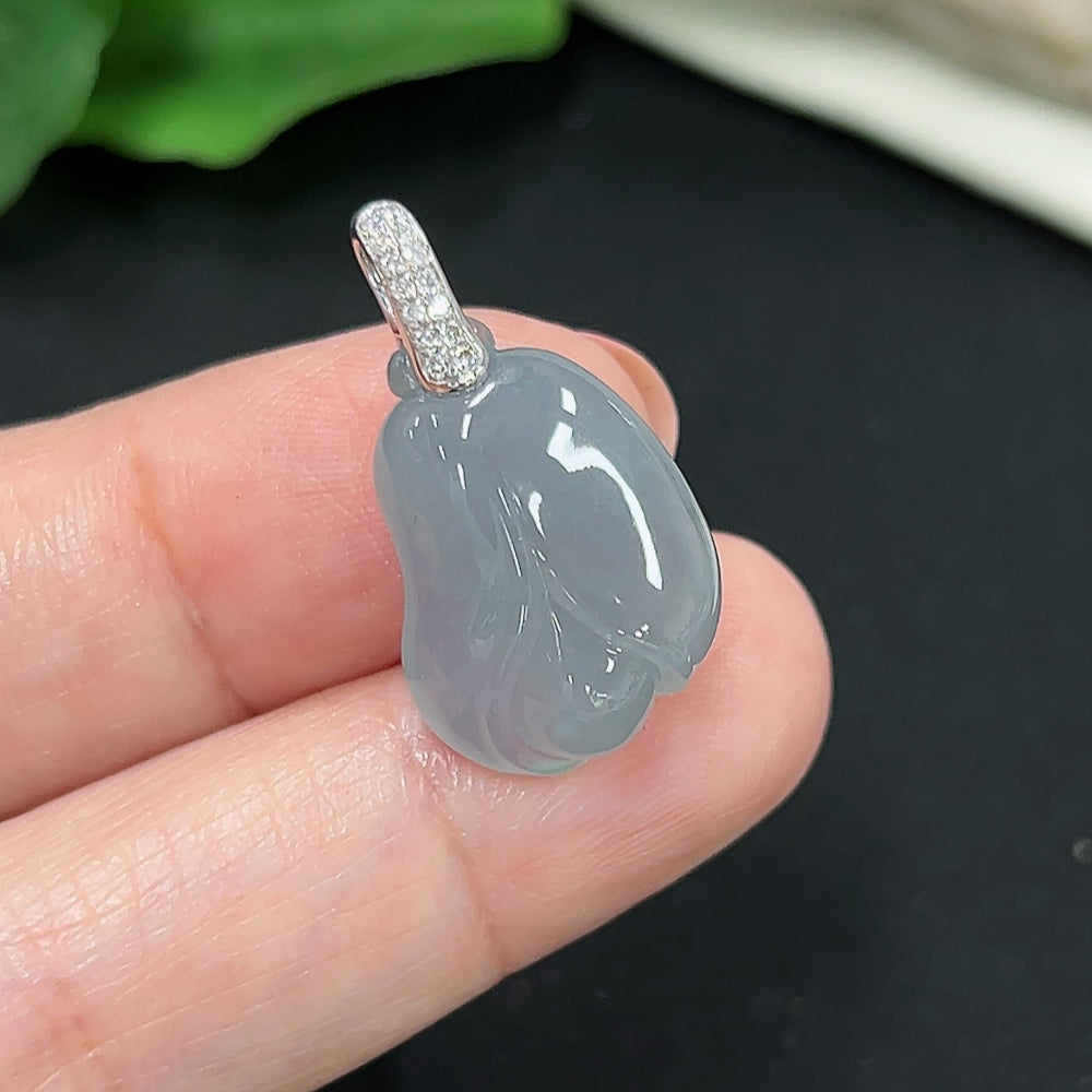 Jadeite pendant with diamond accents in 18K gold, HKHQ, showcasing a polished green jade stone on a delicate chain.