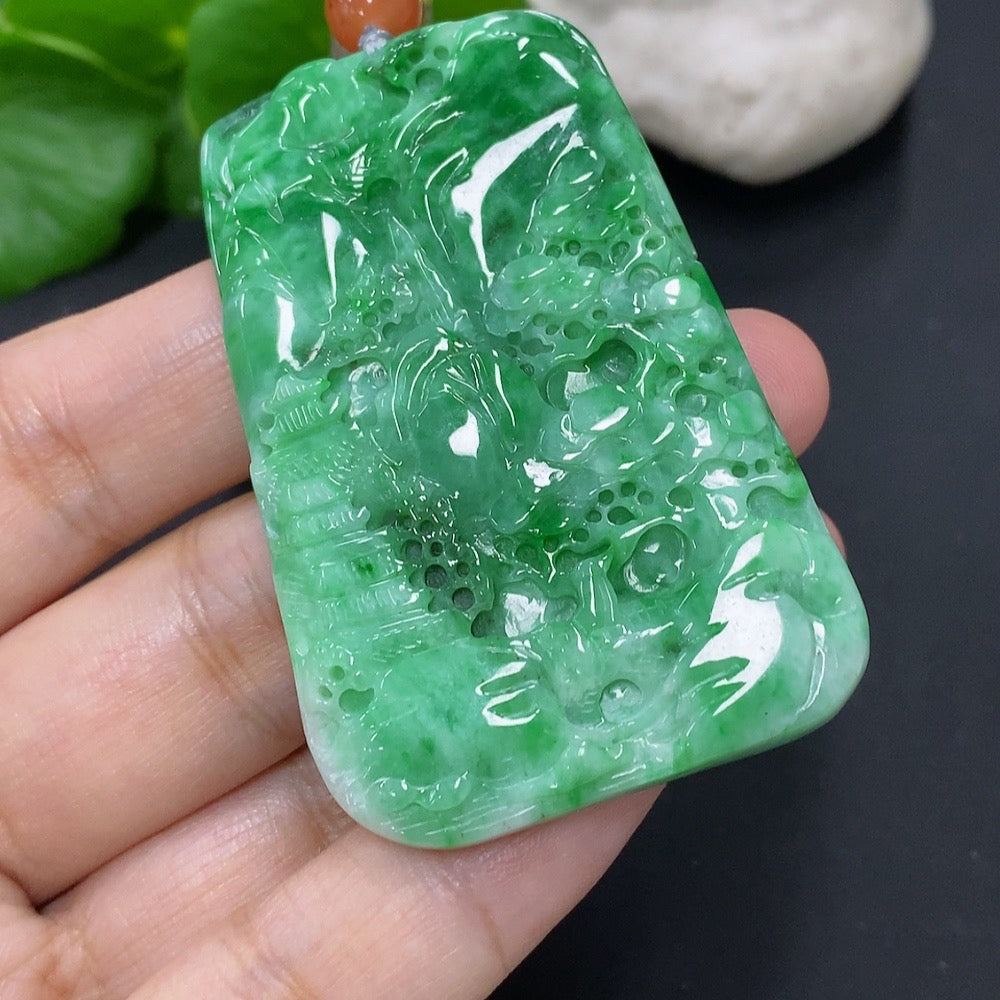 Jadeite landscape pendant by HKHQ with rope, approximately 32.6g, showcasing intricate jade carvings of scenic mountain and water designs.