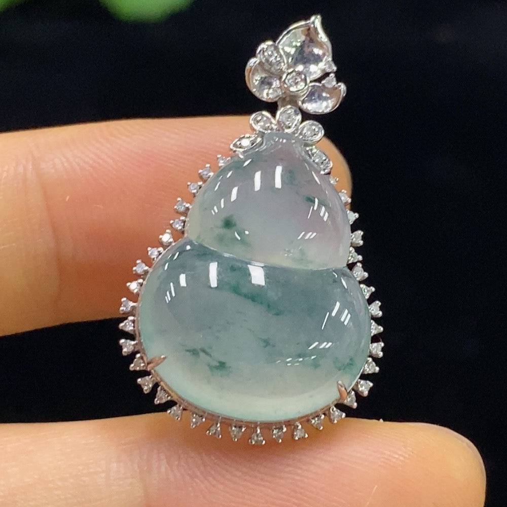 Jadeite gourd pendant with 18K gold and diamond inlays, featuring intricate craftsmanship and a smooth polished surface.