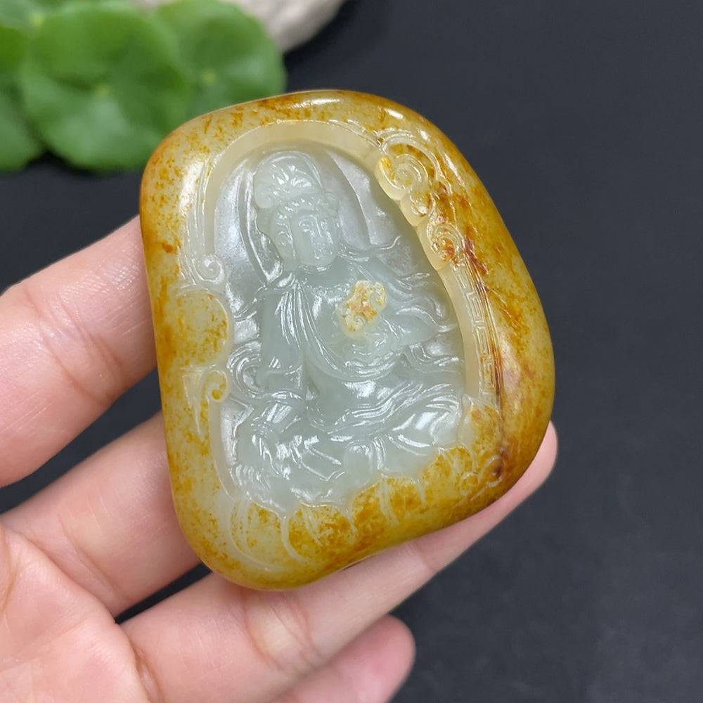 Huiliu certified Hetian jade Guanyin pendant featuring intricate carving and smooth polished surface, hanging on a cord.
