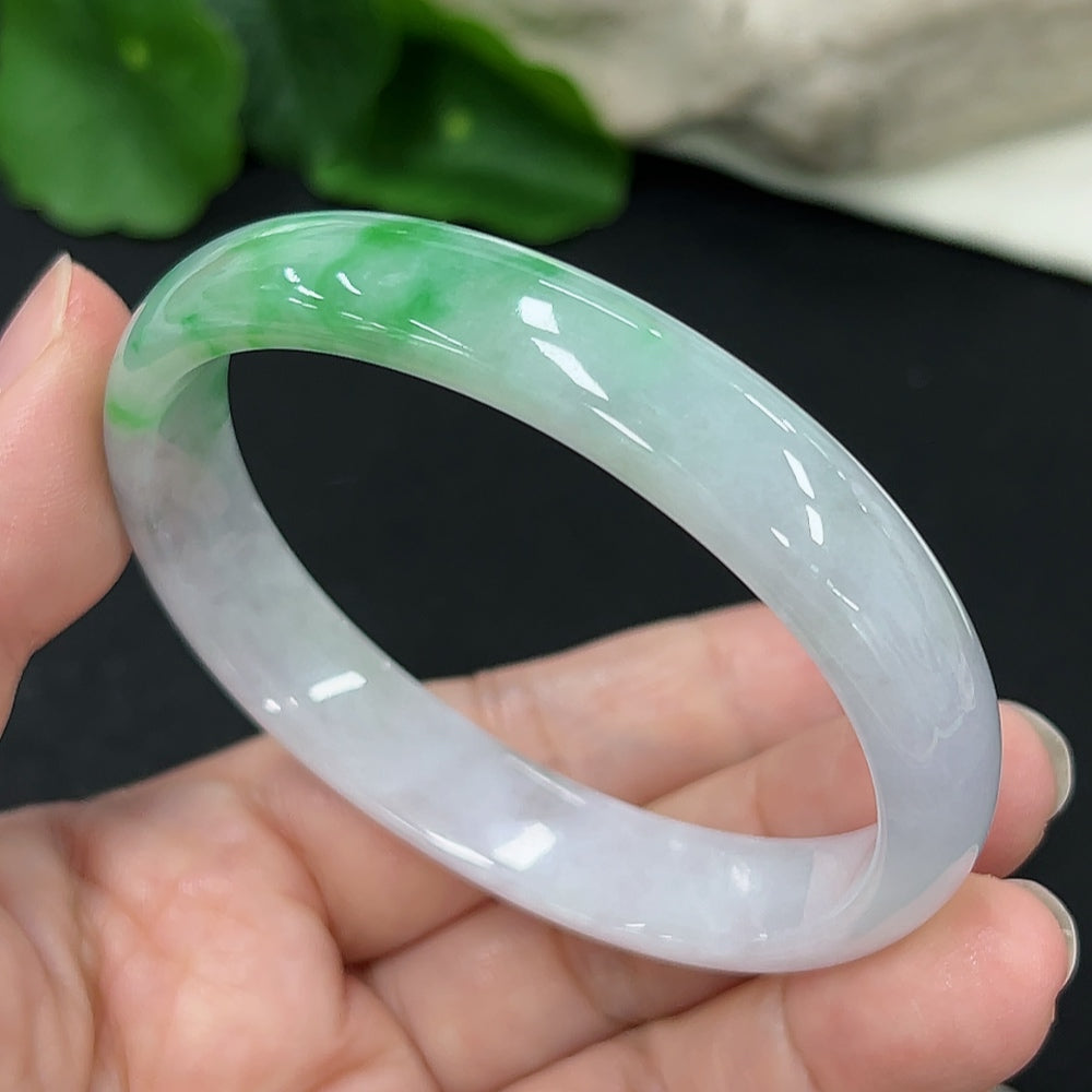 HKHQ jadeite concubine bracelet with carved design, 56.9/48.5 size, approximately 33.8g, showcasing elegant green jade details.