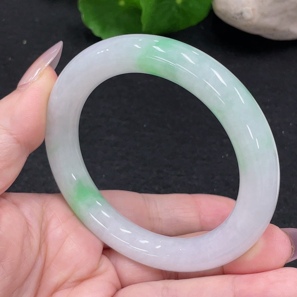 HUILIU HQ jadeite round bangle in size 54, weighing about 57.4g, showcasing smooth, polished jade surface and circular shape.