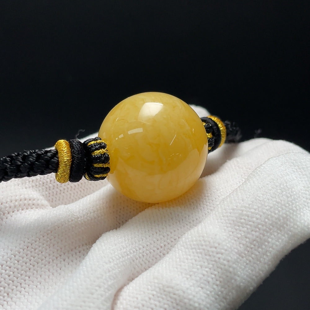 Amber beeswax pendant necklace with cord, approx. 25.2mm, handcrafted jewelry by HKHQ featuring warm amber tones.