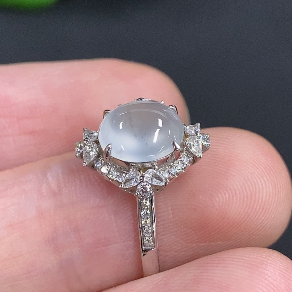 Jadeite cabochon ring with 18k gold band, accented with diamonds, featuring a polished green jadeite stone, size 10.