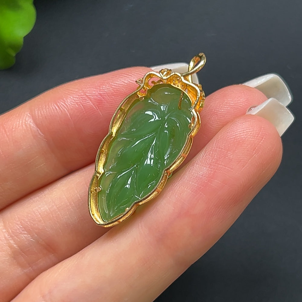 Green Hetian Jade leaf pendant on a gold necklace, crafted with 18K gold, featuring a natural jade leaf design.