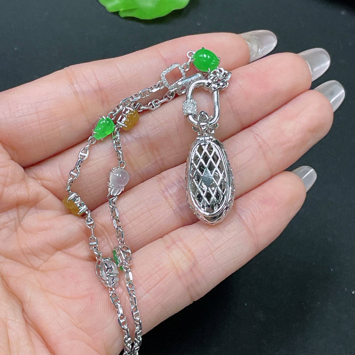 HUILIU HQ jadeite necklace with 18k gold and diamond accents, featuring a detailed jade pendant on a gold chain.