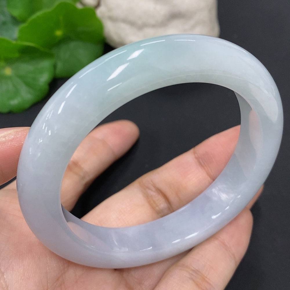 HUILIU HQ jadeite round bangle in size 56, weighing approximately 63.1g, with a smooth polished surface and vibrant green color.
