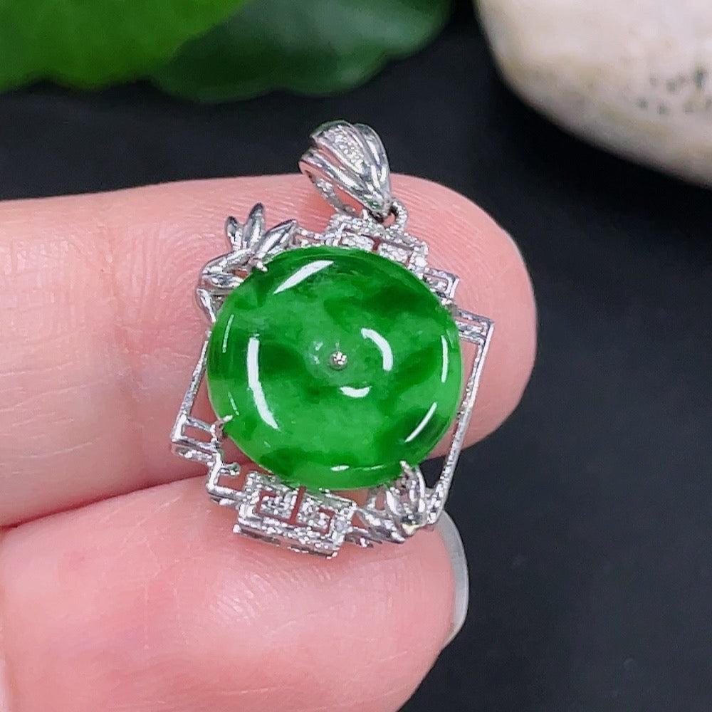 Jadeite inlaid pendant by HUILIU HQ featuring an 18K gold setting, showcasing a polished green jade stone with intricate inlay details.