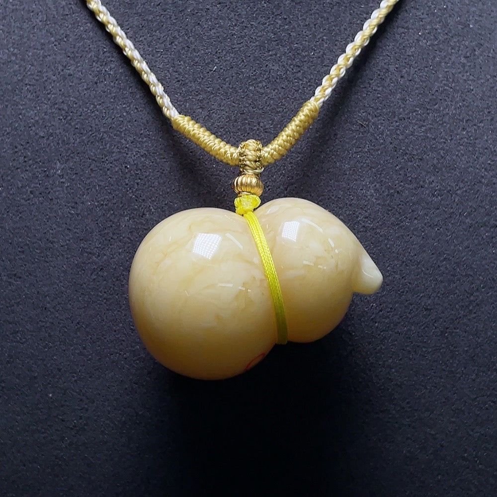 Huiliu amber beeswax pendant with partial visible repairs, showcasing warm amber hues and handcrafted details.