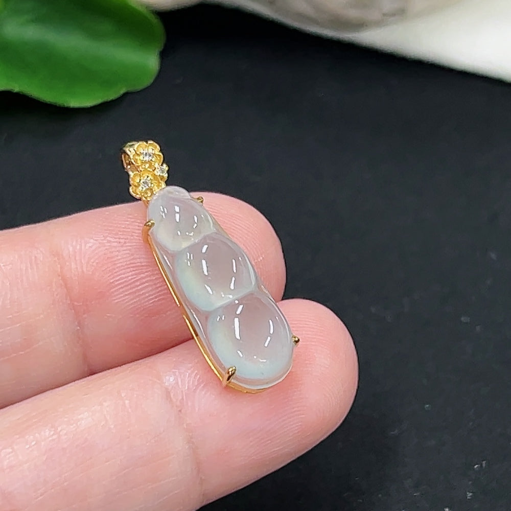 Jadeite auspicious bean pendant in 18K gold with diamond accents, hanging on a delicate necklace chain.