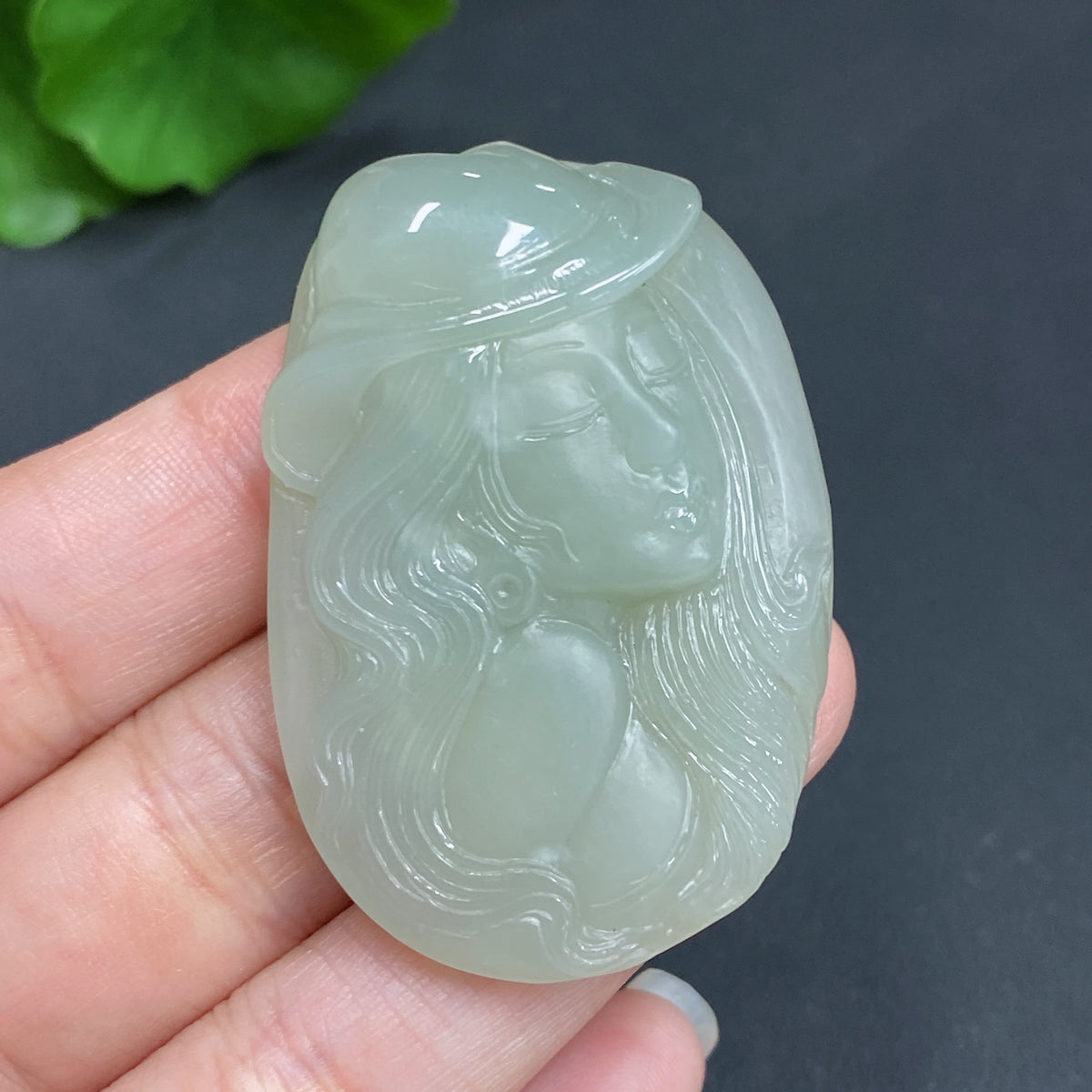Hetian jade pendant with intricate carvings, weighing 21.8g, featuring a traditional design and natural jade color variations.