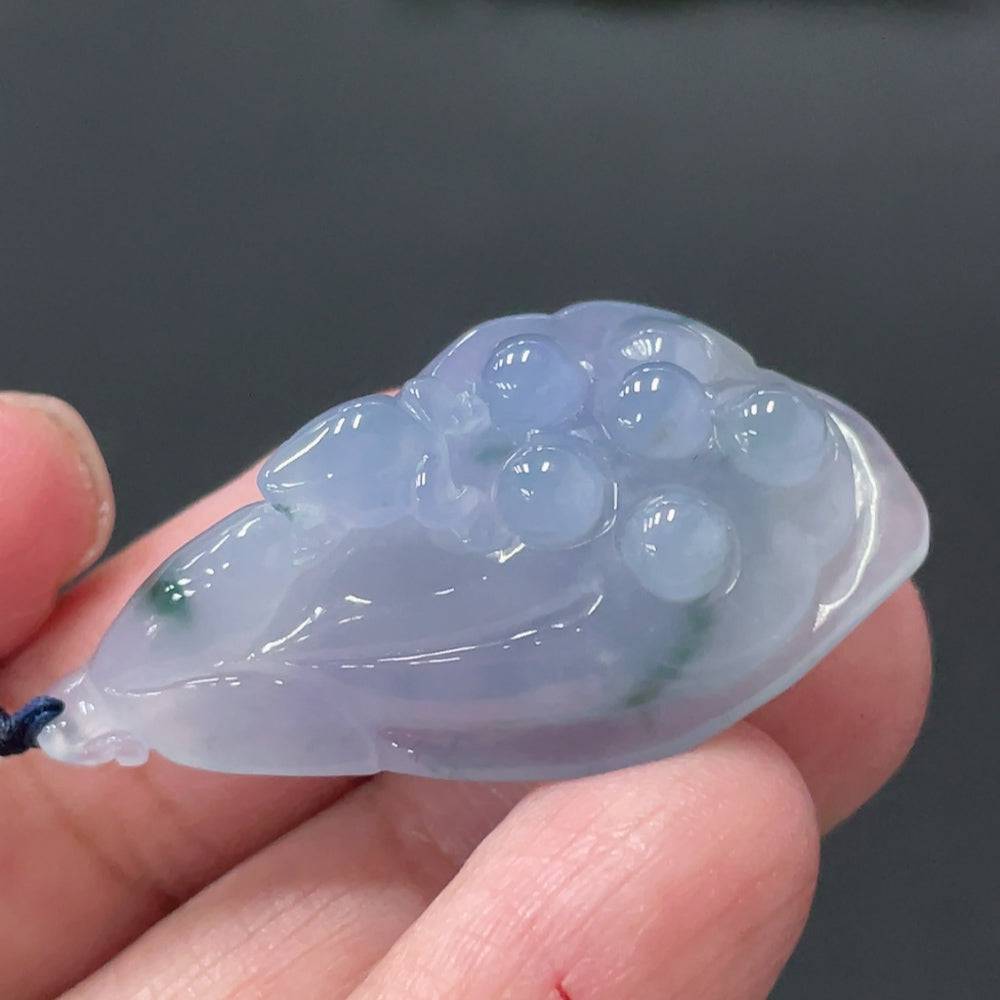 Jadeite lotus pod pendant by HUILIU HQ, showcasing a detailed green jade pendant with a natural lotus design on a white background.