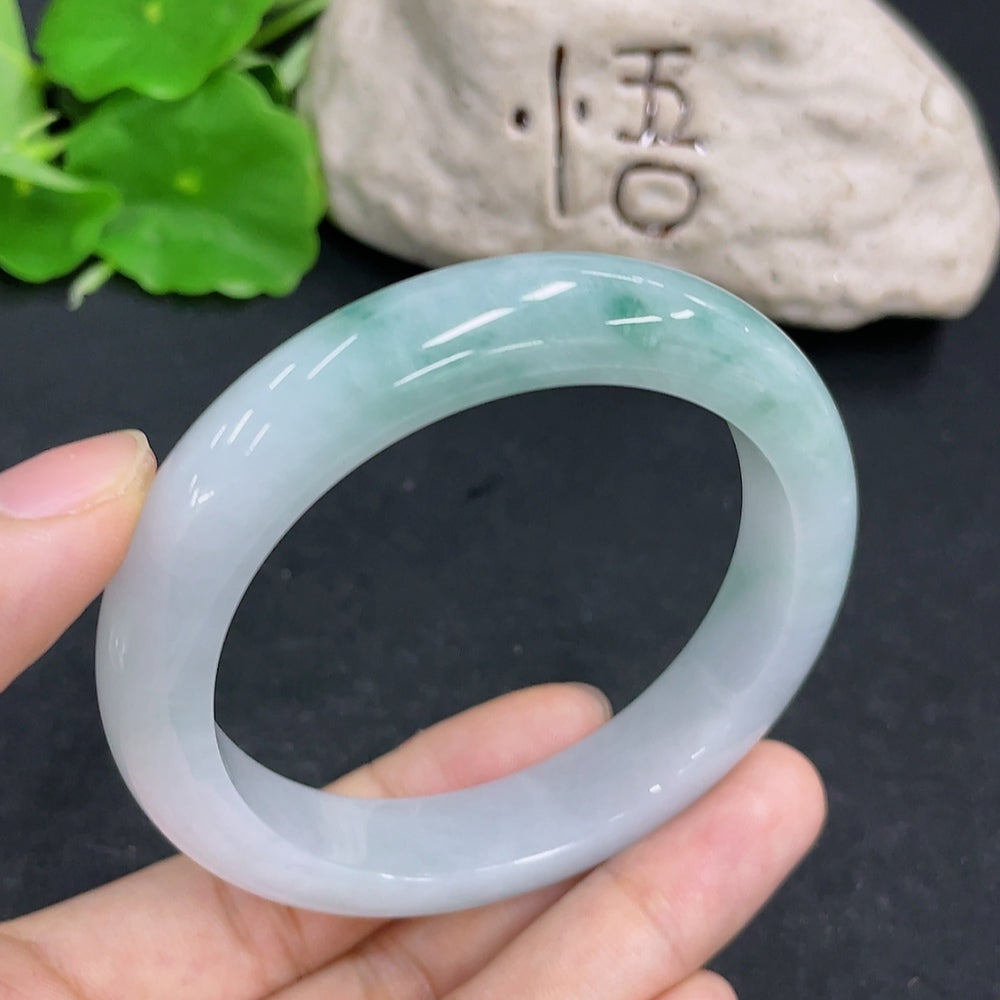 Jadeite round bracelet by HKHQ featuring smooth, polished green jade beads, weighs approximately 58.6 grams, size 56.5 mm.