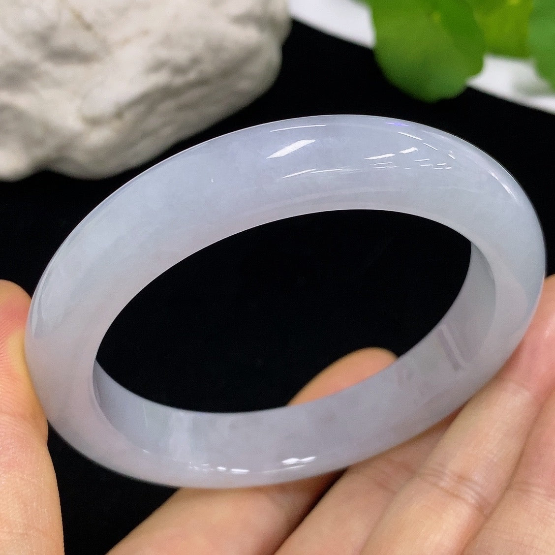 Jadeite round bangle in size 58.8, weighing approximately 64.88g, featuring smooth, polished jade surface with subtle natural patterns.