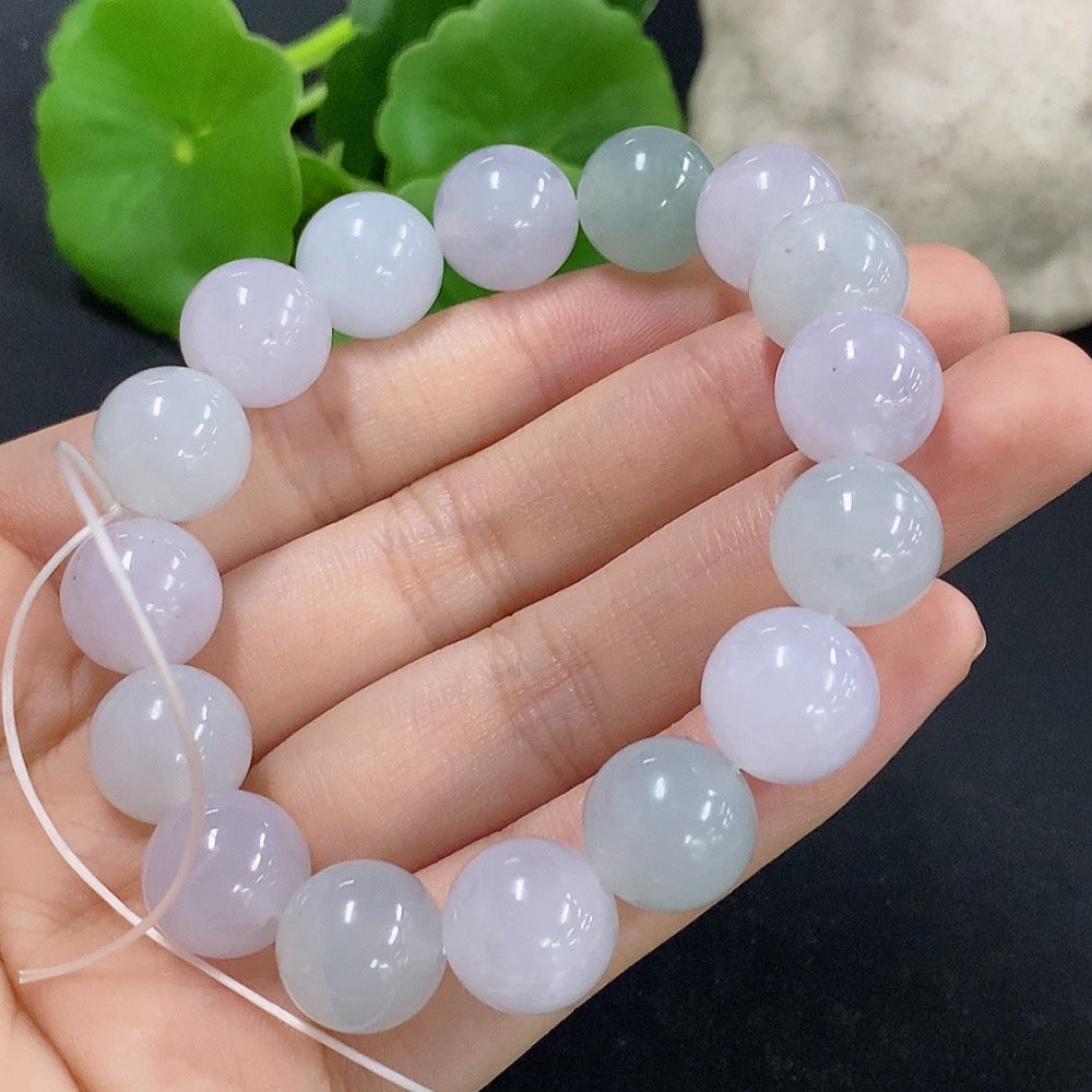 HKHQ jadeite bracelet weighing 48.59g, featuring polished green jadeite beads on a delicate string.