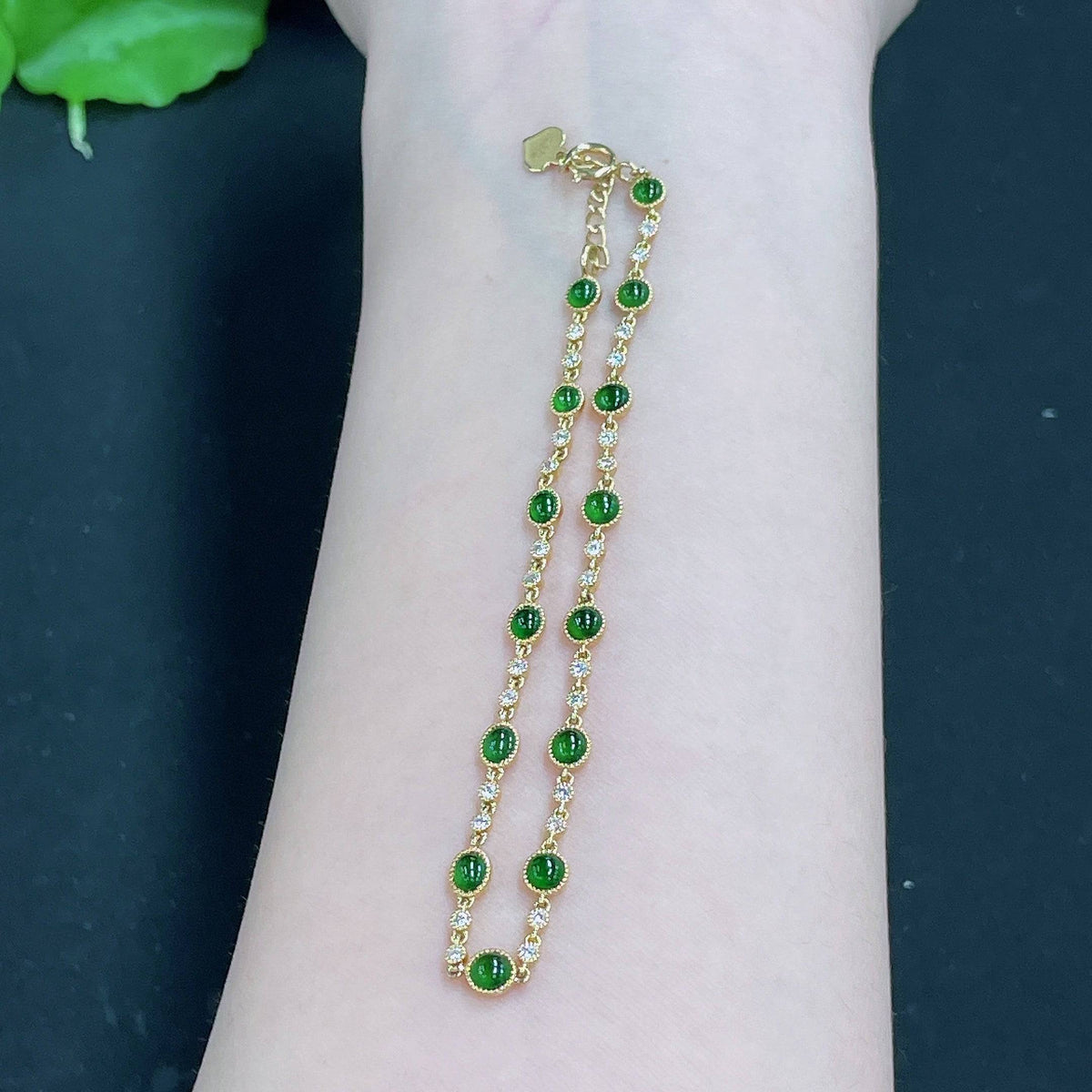HUILIU HQ jadeite cabochon inlaid bracelet with 18k gold and diamond accents, showcasing polished jade stones and elegant design