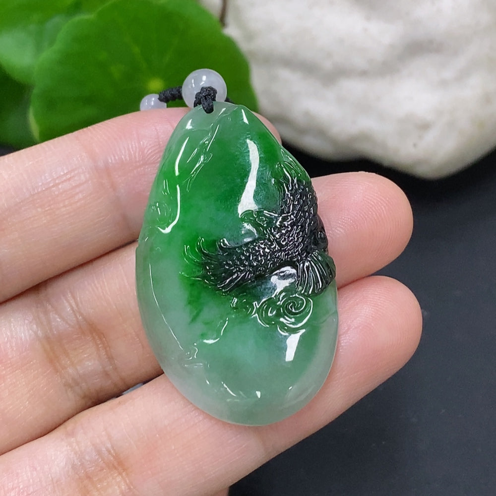 HKHQ jadeite pendant with mineral components, 19.9g including chain, showcasing green jade and mixed mineral details.