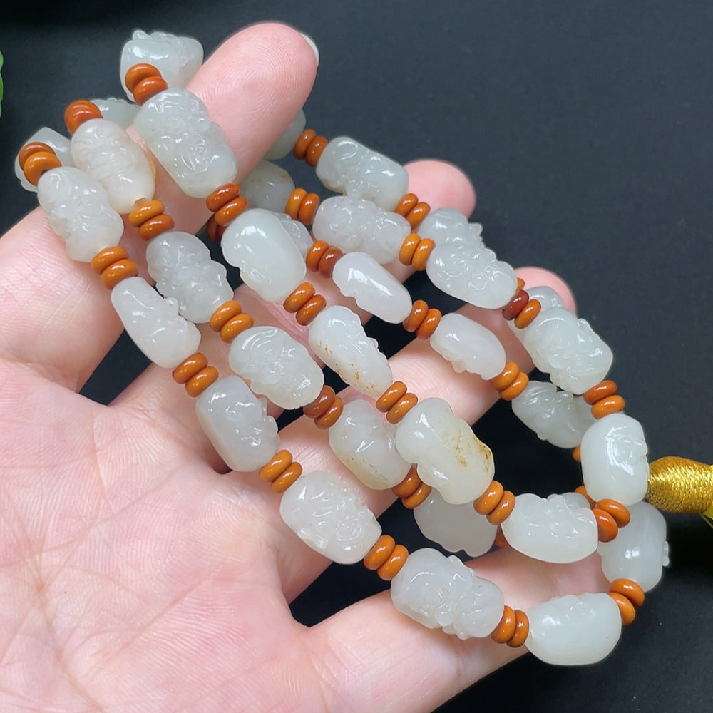 HKHQ Hetian Jade Eighteen Arhats bracelet with colorful beads and string, weighs approximately 65.71g, unconfirmed jade origin.