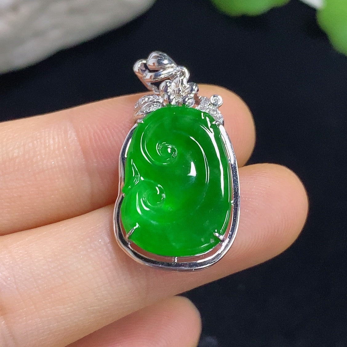 Jadeite Ruyi pendant with 18k gold inlay and diamond accents, showcasing intricate craftsmanship and elegant design.