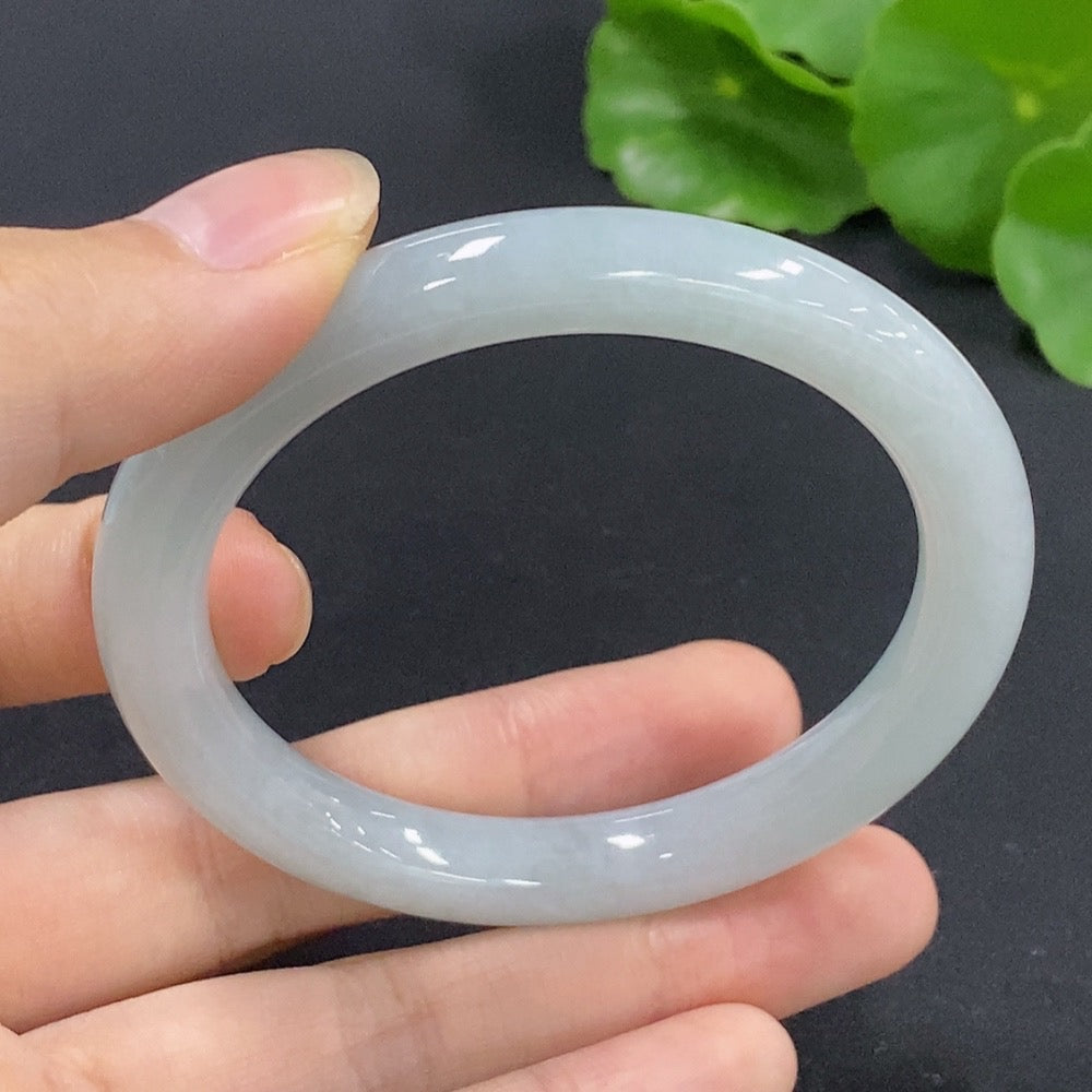 Jadeite round bangle in size 52, weighing approximately 35.12g, crafted by HKHQ, showcasing smooth, polished jade jewelry.