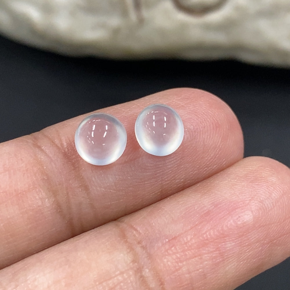 Close-up of a smooth, polished jadeite cabochon jewelry piece weighing 0.49g, showcasing vibrant green color and glossy surface.