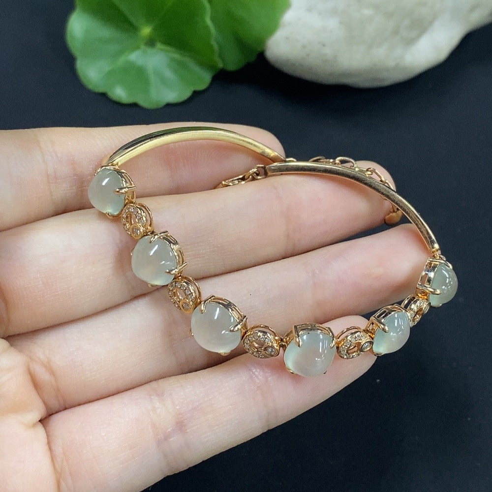 Jadeite cabochon bracelet set in 18K gold with diamond accents, total weight approximately 10.85g