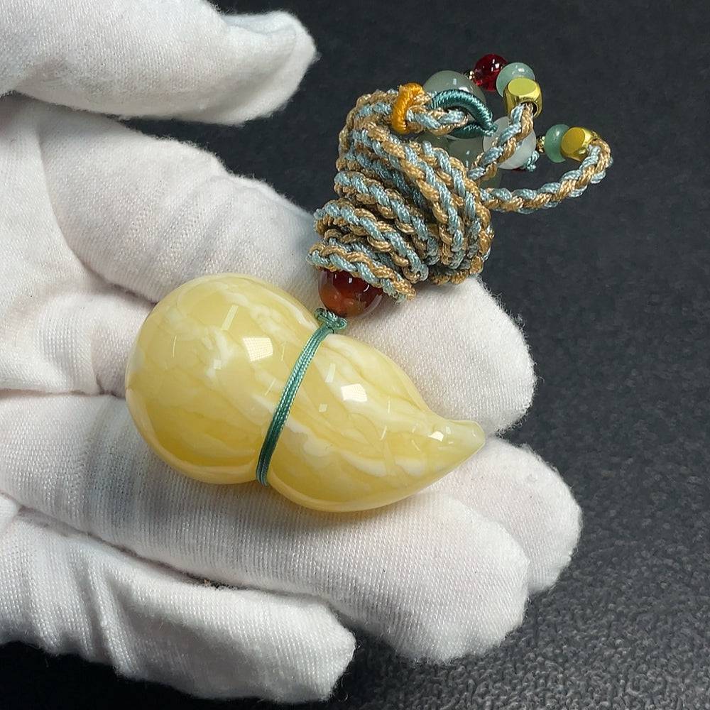 Amber beeswax pendant with rope from HUILIU HQ, featuring a warm amber color and natural handcrafted design.