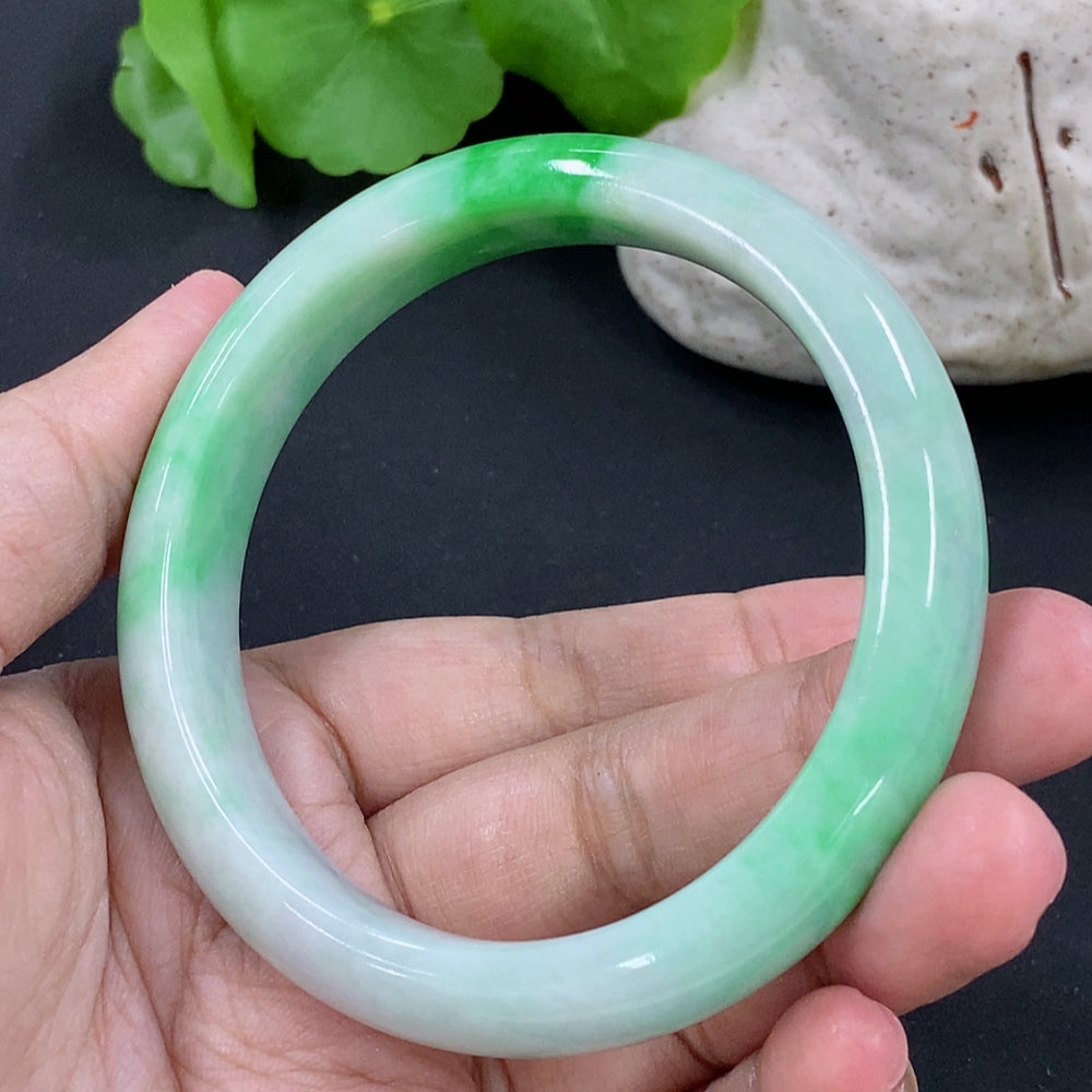 HKHQ jadeite round bracelet weighing 54.97g with size 56.9, featuring smooth, polished jadeite beads in natural green tones.