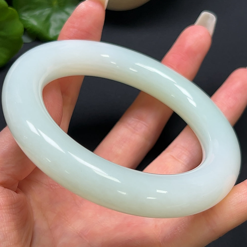 Hetian jade round bangle bracelet in size 61.5 with 96.73g weight, crafted by HKHQ, showcasing smooth, polished jade surface.