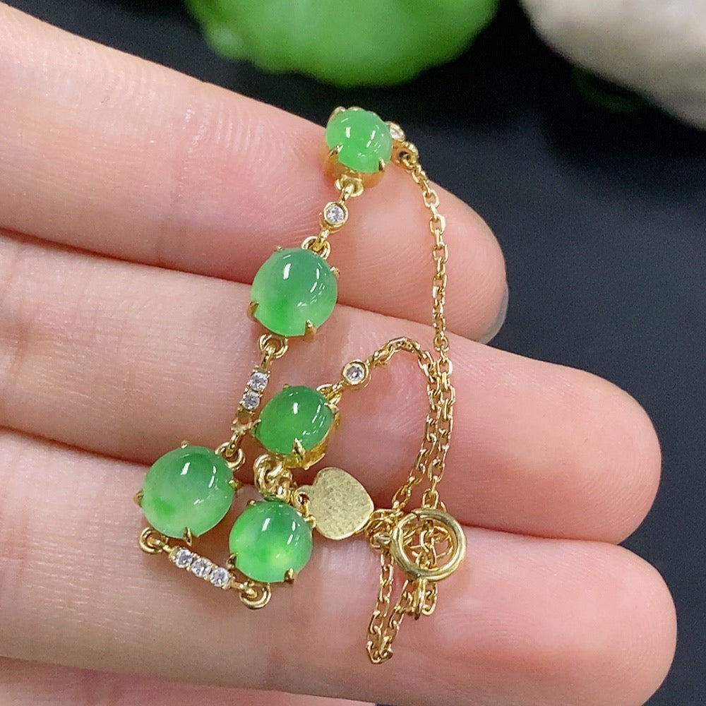 Jadeite cabochon bracelet with 18k gold and diamond accents, HKHQ jewelry, showcasing smooth green jade stones and elegant design
