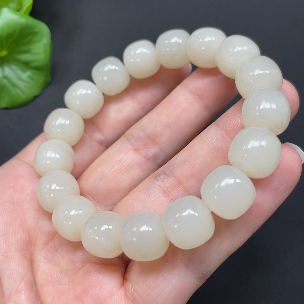HKHQ Hetian Jade bracelet with 12mm smooth jade beads, approximately 49.78g, showcasing elegant craftsmanship and natural green color.