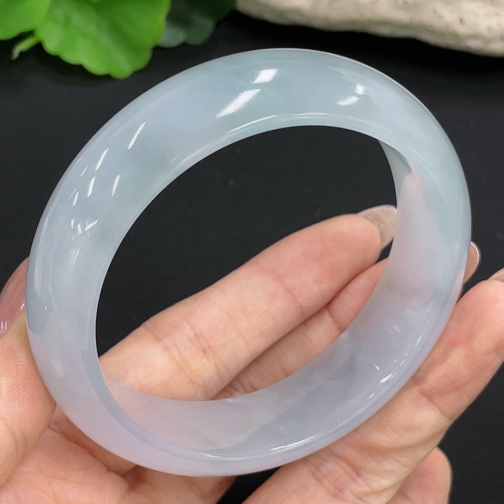 Jadeite round bracelet by HKHQ with 77.6g weight and size 58.4, featuring polished green jade beads on a string.
