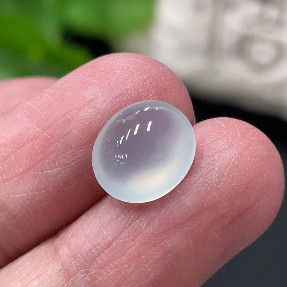 Jadeite cabochon with a smooth, polished surface, weighing approximately 0.73g, from HUILIU HQ, showcasing vibrant green jade color.