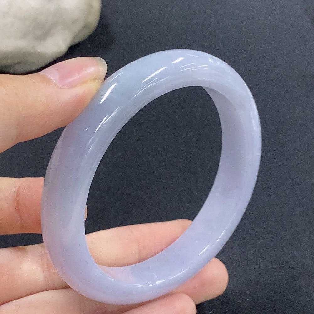 Jadeite round bangle in size 56.1 with an approximate weight of 53.9g, showcasing smooth, polished jadeite material.