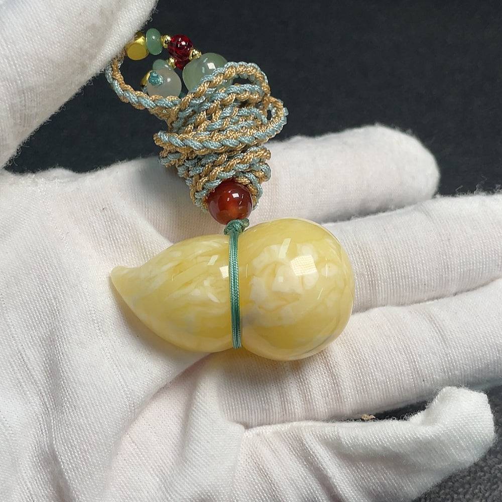 HUILIU HQ amber beeswax pendant with rope, showcasing a smooth, natural amber piece with a simple cord for wearing.